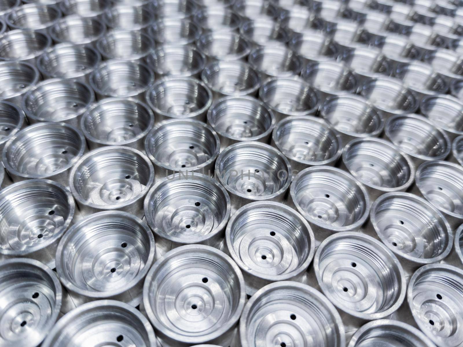 abstract industrial close-up background of shiny steel turned parts.