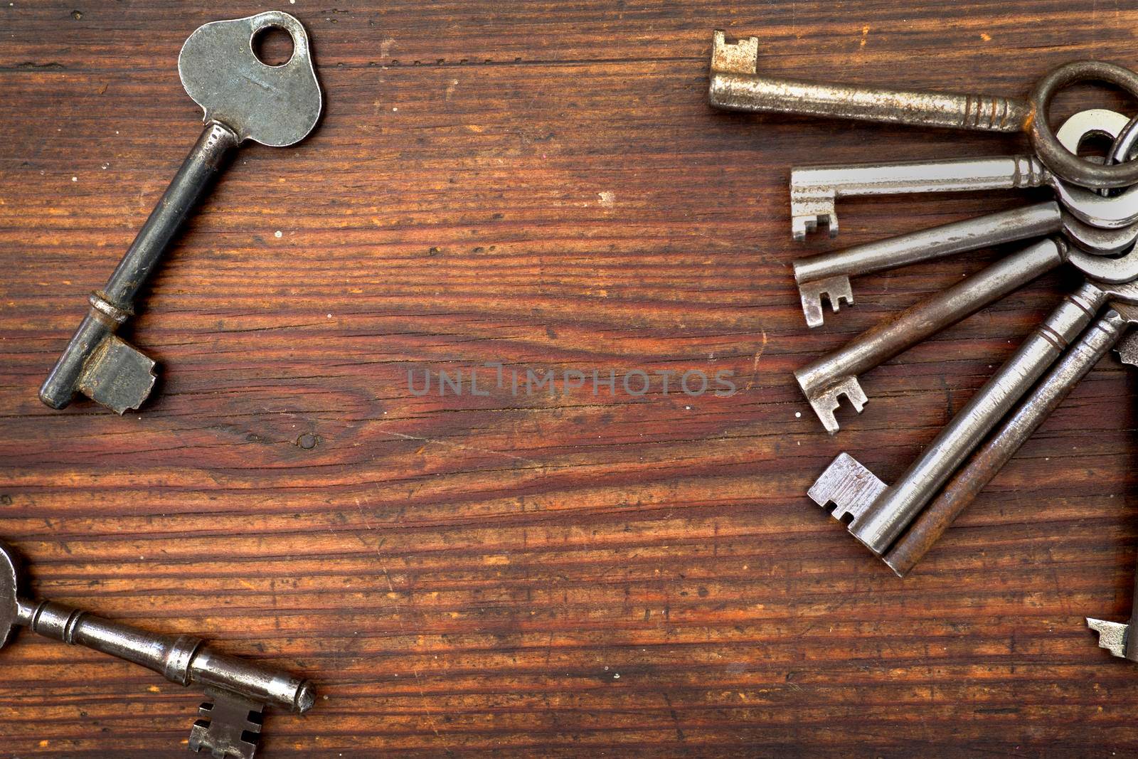 Old keys arranged on wood, flat lay