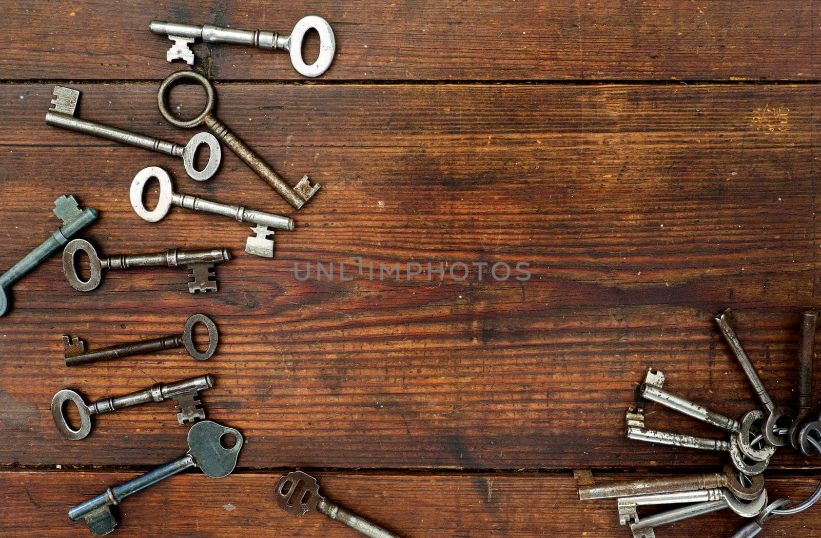 Old keys on textured wooden background by fivepointsix