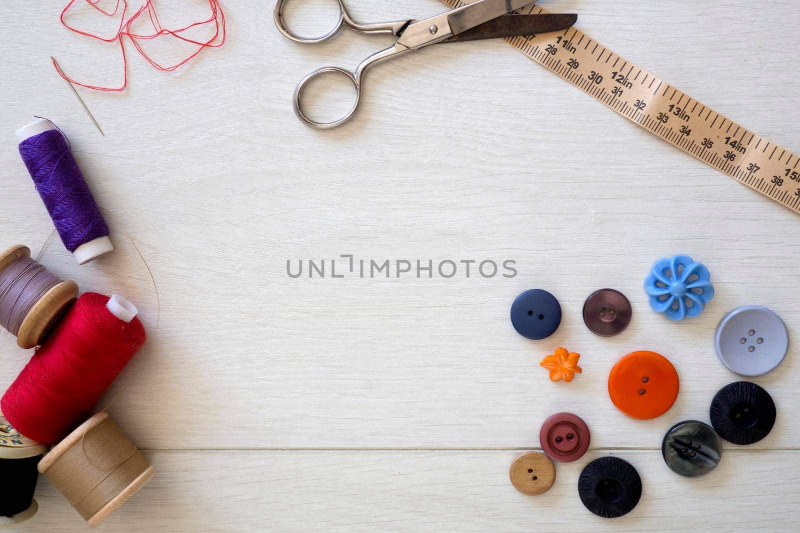 Brightly colored buttons and sewing cotton, flat lay