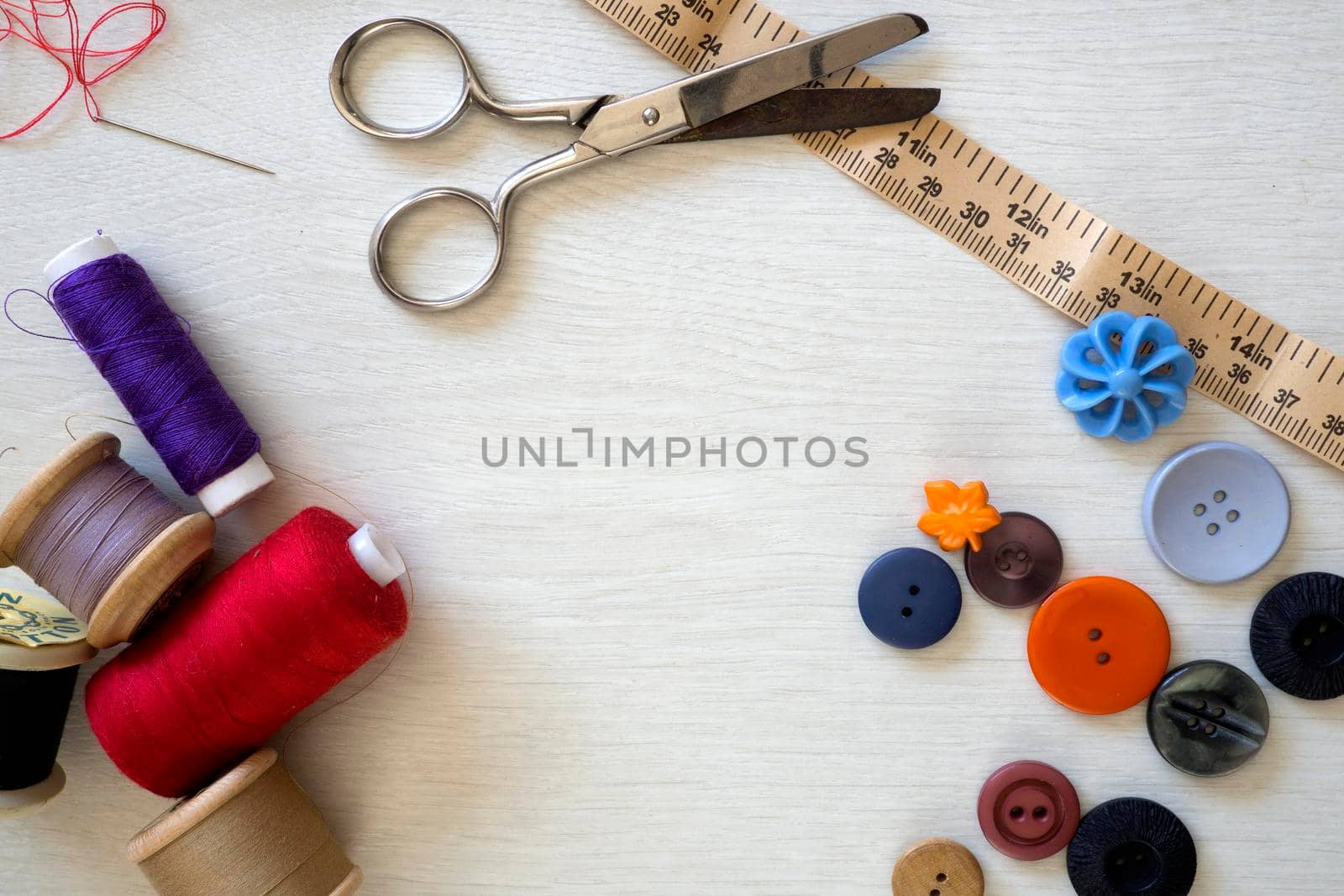 Brightly colored buttons and sewing cotton, flat lay