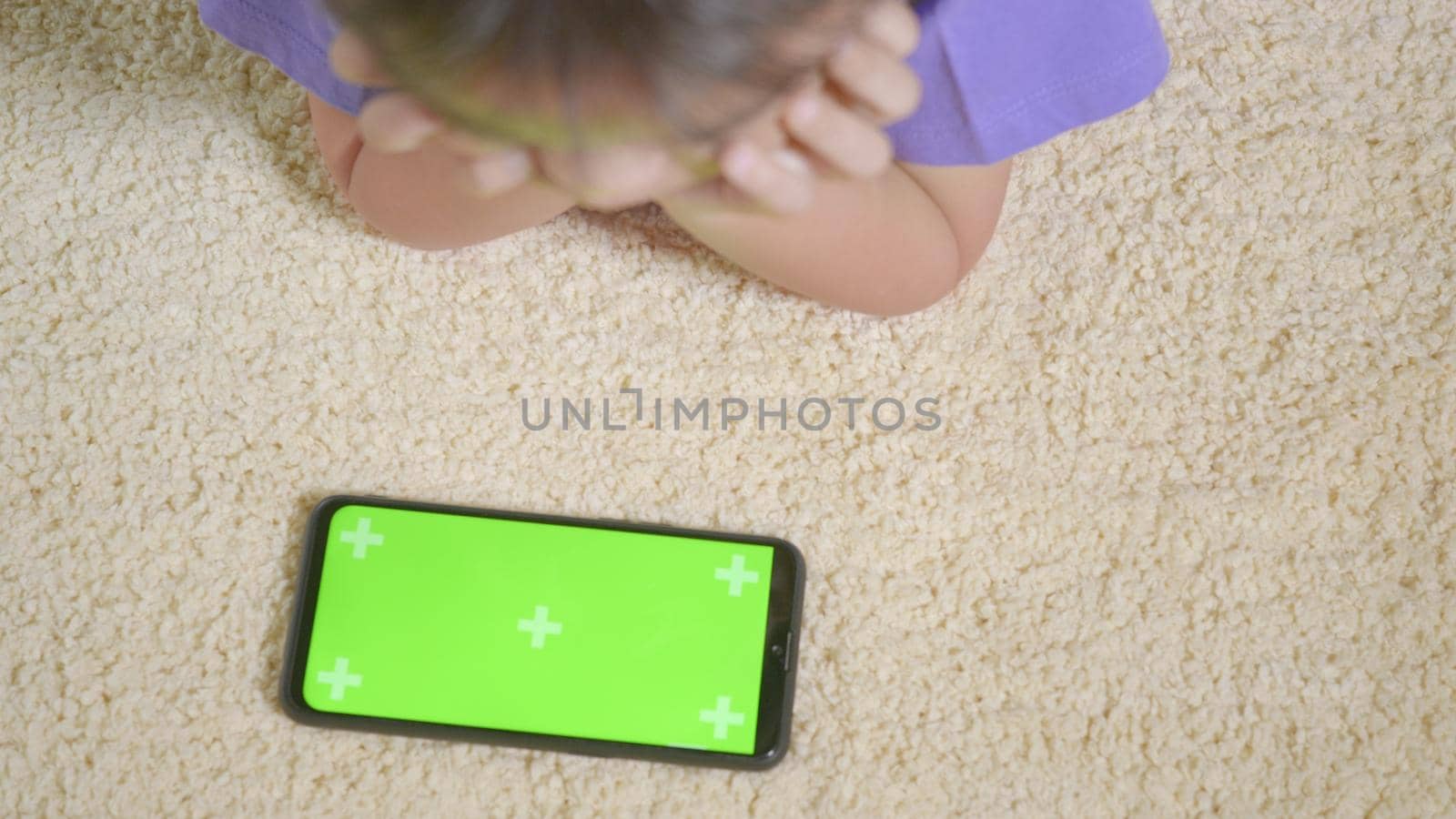 Asian kid boy preschool with gadget playing video games digital on mobile phone at home. Little child using and holding a smartphone green screen in hand, Technology generation concept