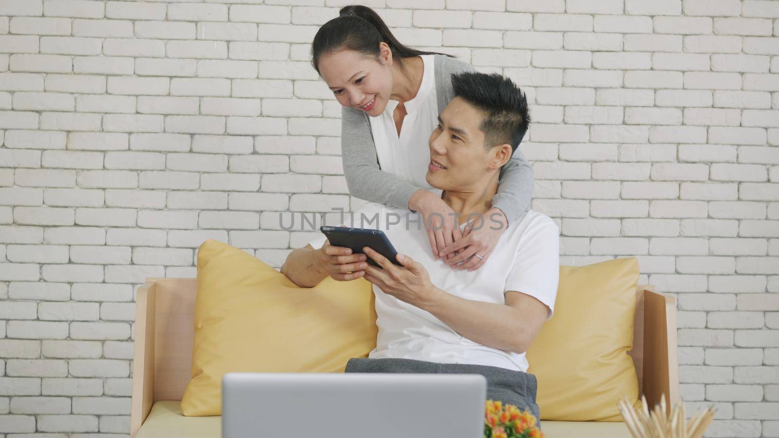family couple husband and wife work and using digital tablet by Sorapop