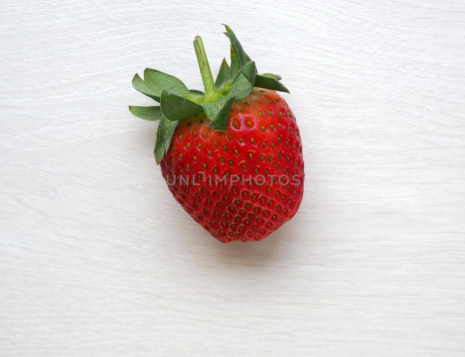 Strawberry on white wood background by fivepointsix