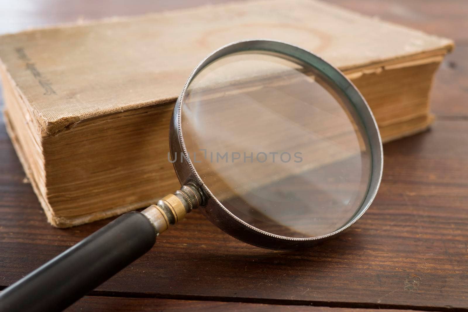 Magnifying glass and old book by fivepointsix
