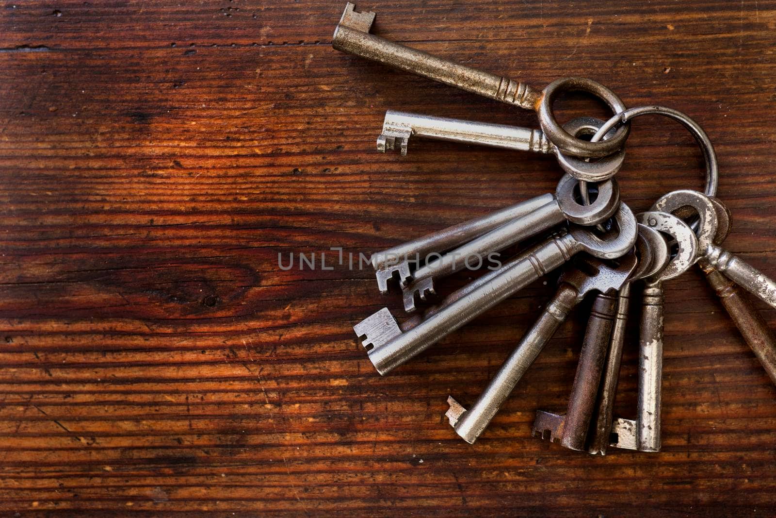 Old keys arranged on wood, flat lay by fivepointsix