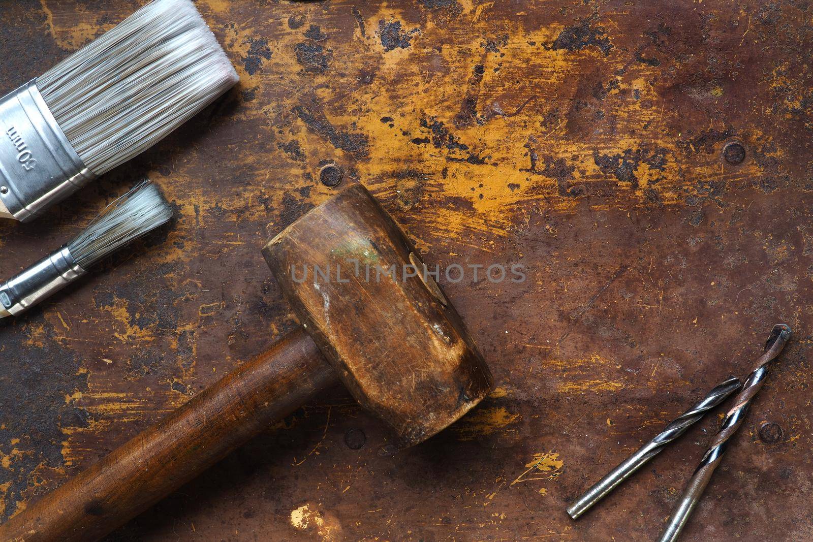 Mallet and paint brushes on textured surface by fivepointsix