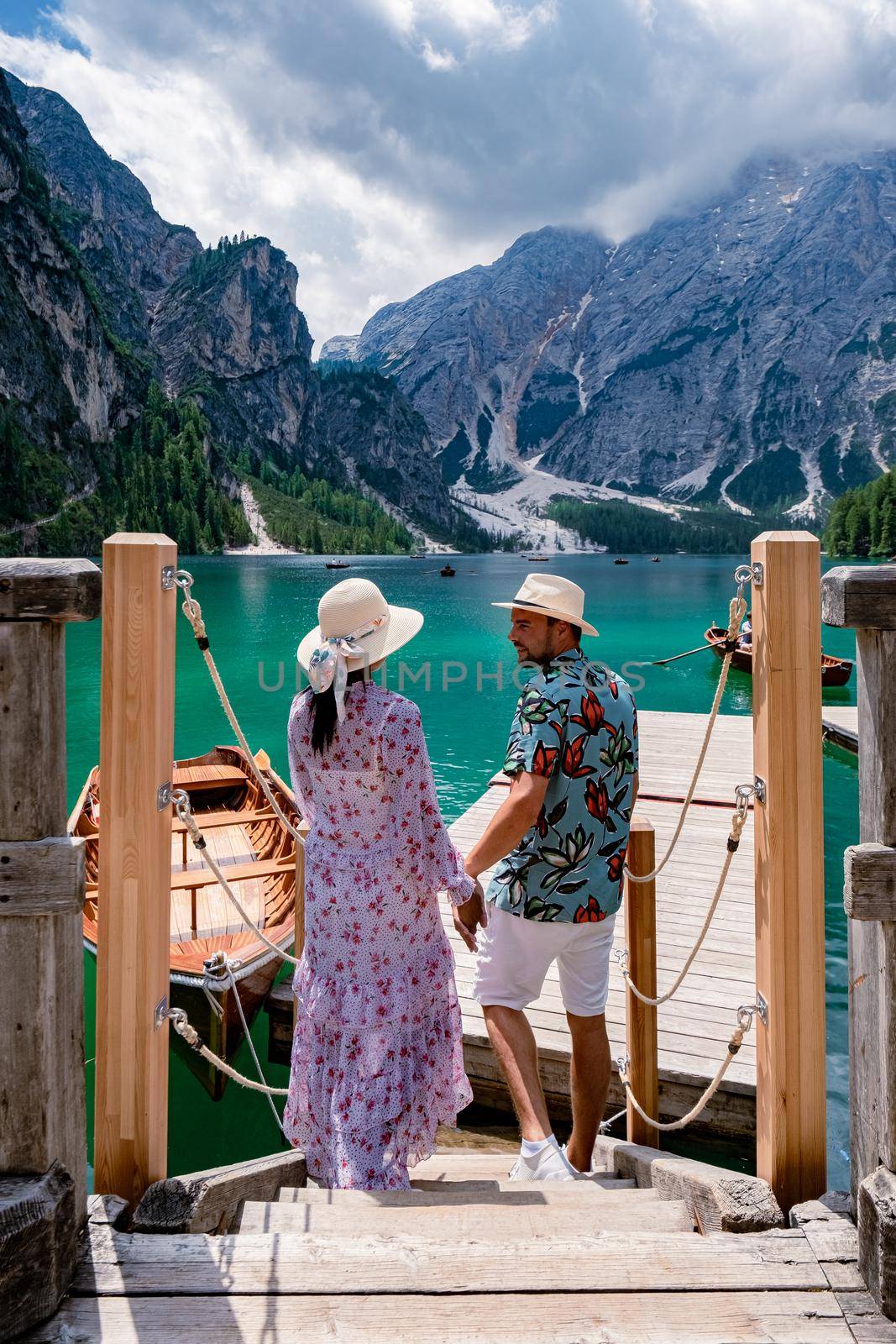 Beautiful lake in the Italian Alps, Lago di Braies in the Italian Dolomites Europe. Braies lake, Italy. The famous lake in the Dolomites, a couple of men and woman mid-age visit Prager wildsee rowing boat