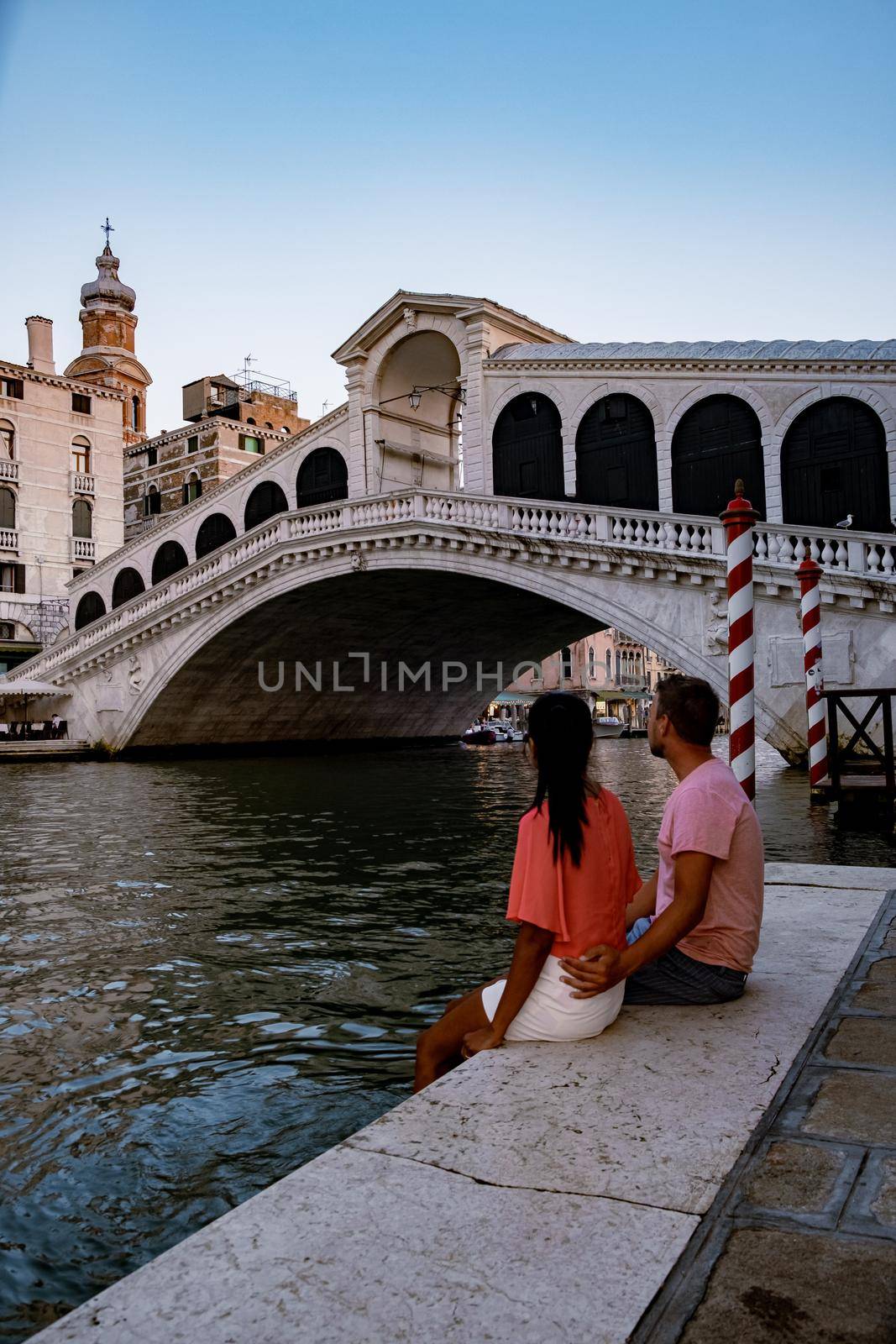 Canals of Venice Italy during summer in Europe,Architecture and landmarks of Venice. Italy Europe, couple men and woman looking at Rialto Bridge Venice