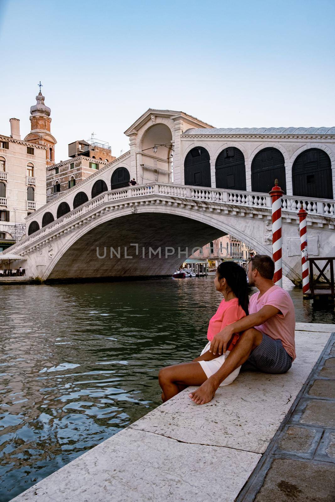 Canals of Venice Italy during summer in Europe,Architecture and landmarks of Venice. Italy Europe, couple men and woman looking at Rialto Bridge Venice