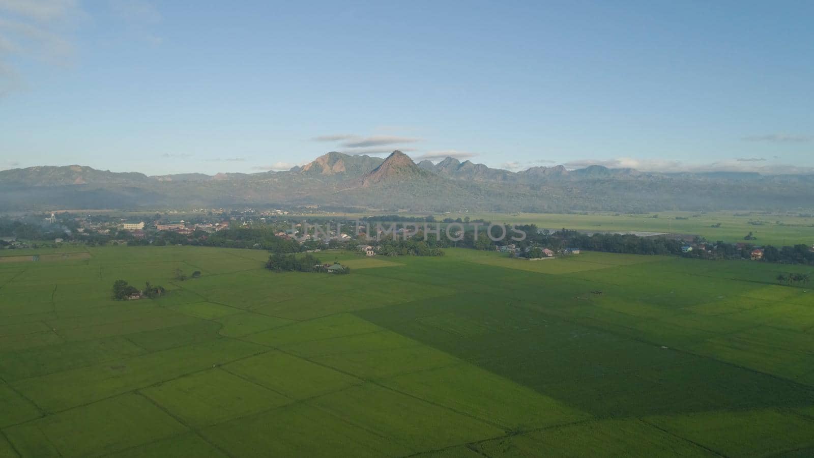 Aerial view: villages, farmer fields, rice terraces in mountain valley. Philippines, Luzon. Rice terraces in a mountain province. Tropical landscape in Asia.