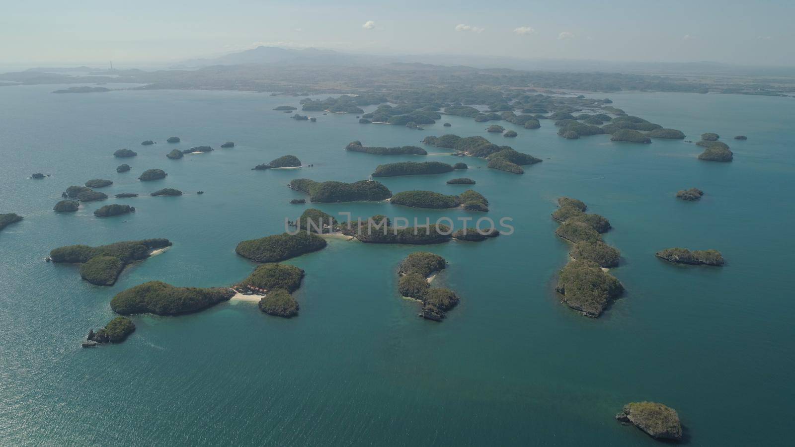 Aerial view of Small islands with beaches and lagoons in Hundred Islands National Park, Pangasinan, Philippines. Famous tourist attraction, Alaminos.