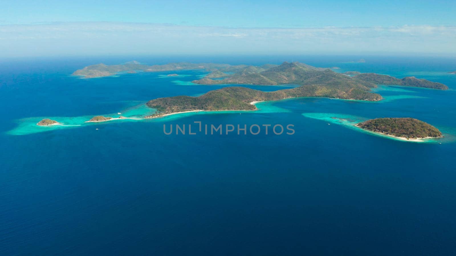 aerial seascape Lagoons with blue, azure water in middle of small islands. Palawan, Philippines. tropical islands with blue lagoons, coral reef. Islands of the Malayan archipelago with turquoise lagoons.