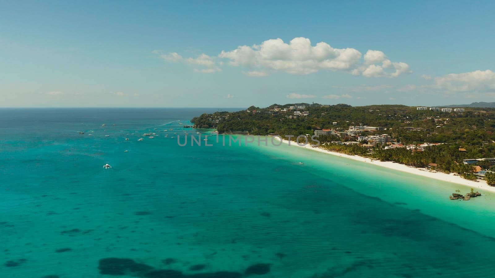 Tropical beach with tourists and clear blue sea, top view. Summer and travel vacation concept. Boracay, Philippines