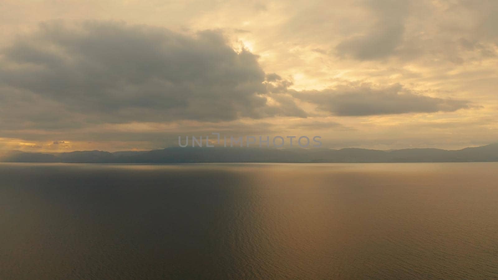 Beauty of colorful sky during the sunset from above. Beautiful sunset background from the colorful beams on the sky. Sunset over ocean. Seascape, Summer and travel vacation concept