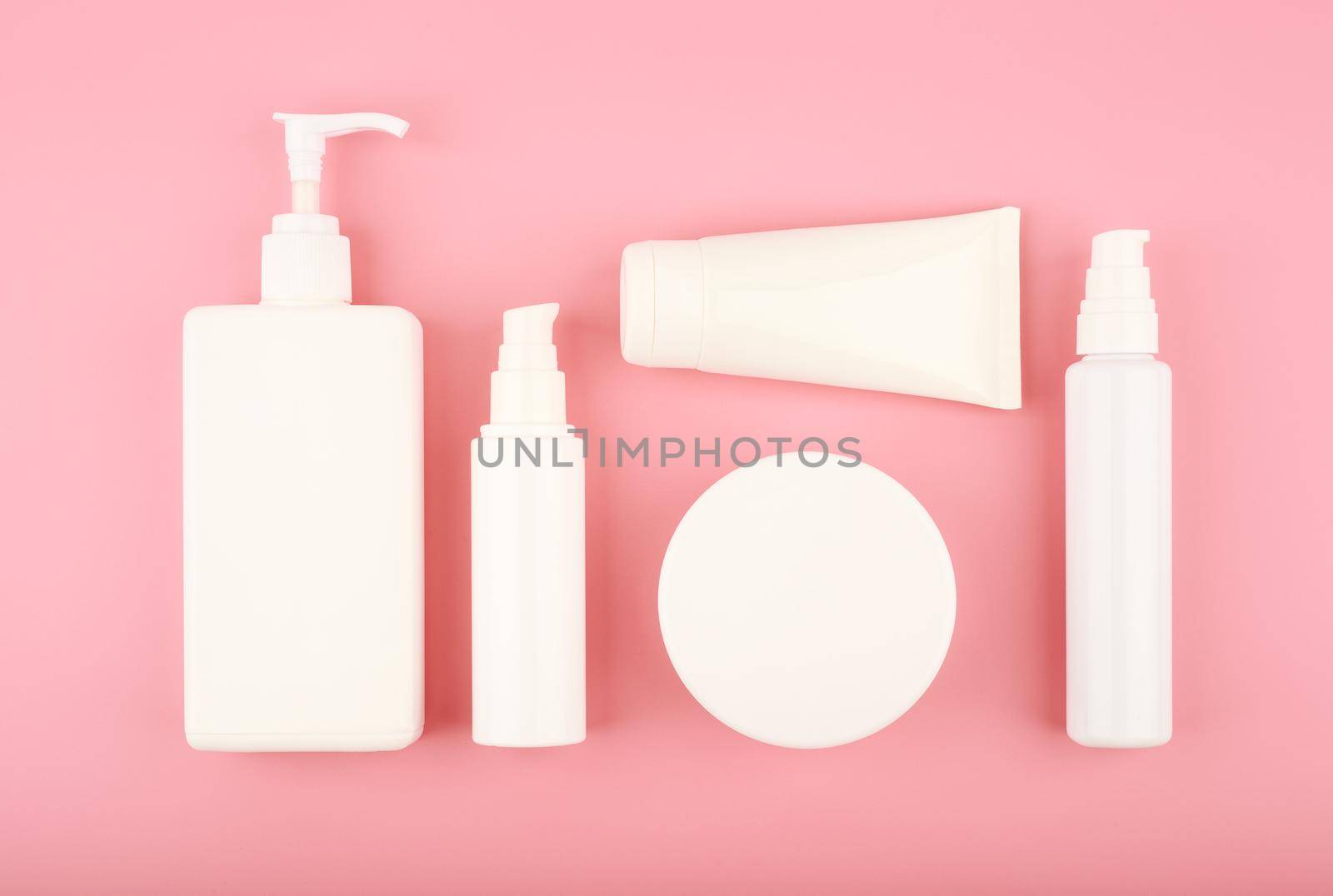 Flat lay with cosmetic products for skin care on bright pink background by Senorina_Irina