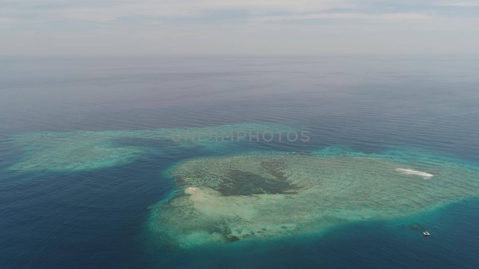 seascape aerial view coral reef, atoll with turquoise water in sea.Tropical atoll, coral reef in ocean waters. Travel concept.