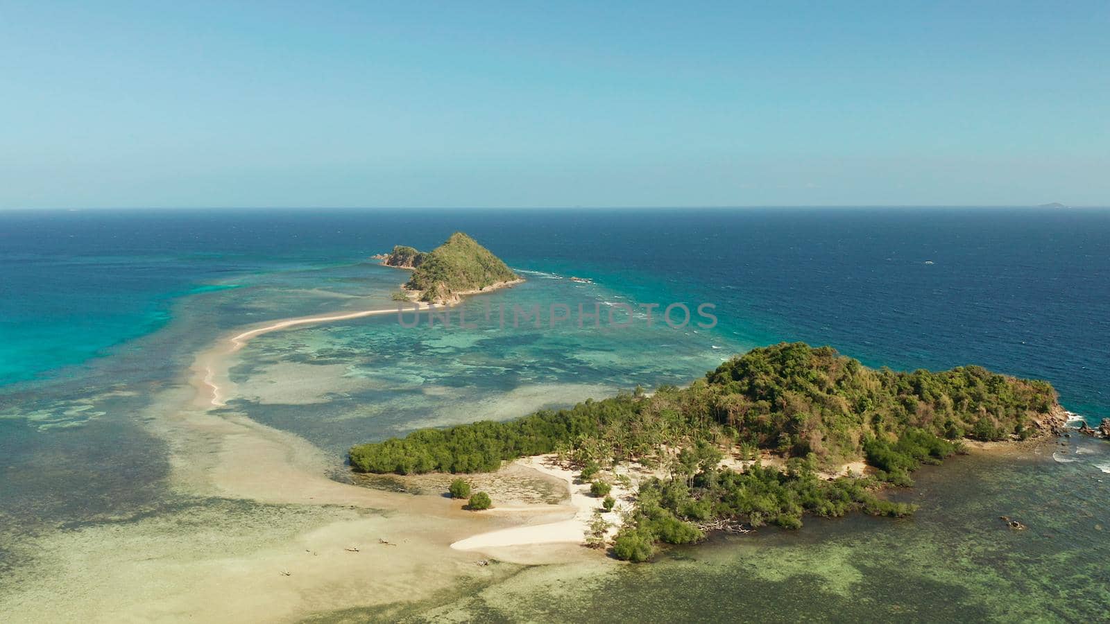 Aerial drone tropical island in blue lagoon with sand bar. Palawan, Philippines. tropical landscape with island and beache