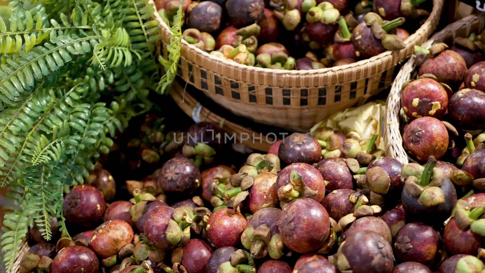 Fruits and vegetables on rustic stall. Assorted fresh ripe fruits and vegetables placed on rustic oriental stall in market. sweet tropical purple mangosteen. Queen of fruits in Thailand.