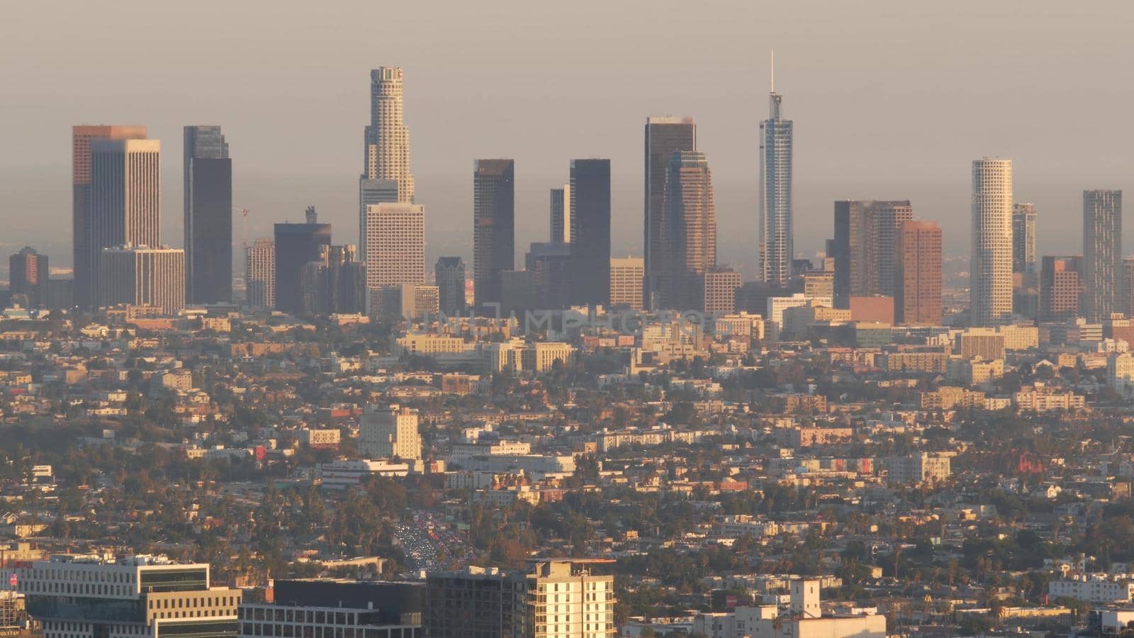 Highrise skyscrapers of metropolis in smog, Los Angeles, California USA. Air toxic pollution and misty urban downtown skyline. Cityscape in dirty fog. Low visibility in city with ecology problems.