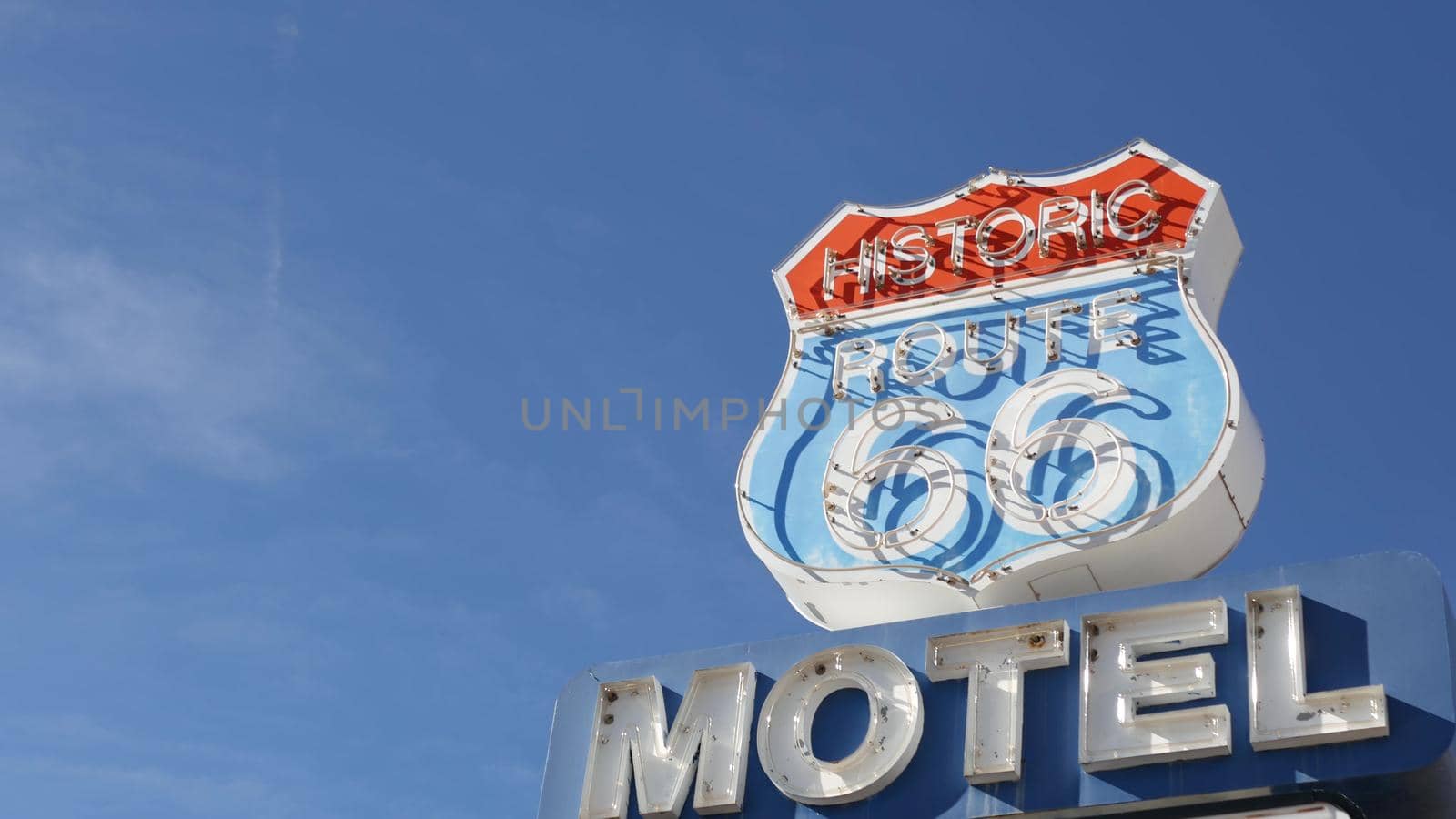 Motel retro sign on historic route 66 famous travel destination, vintage symbol of road trip in USA. Iconic lodging signboard in Arizona desert. Old-fashioned neon signage. Classic tourist landmark.