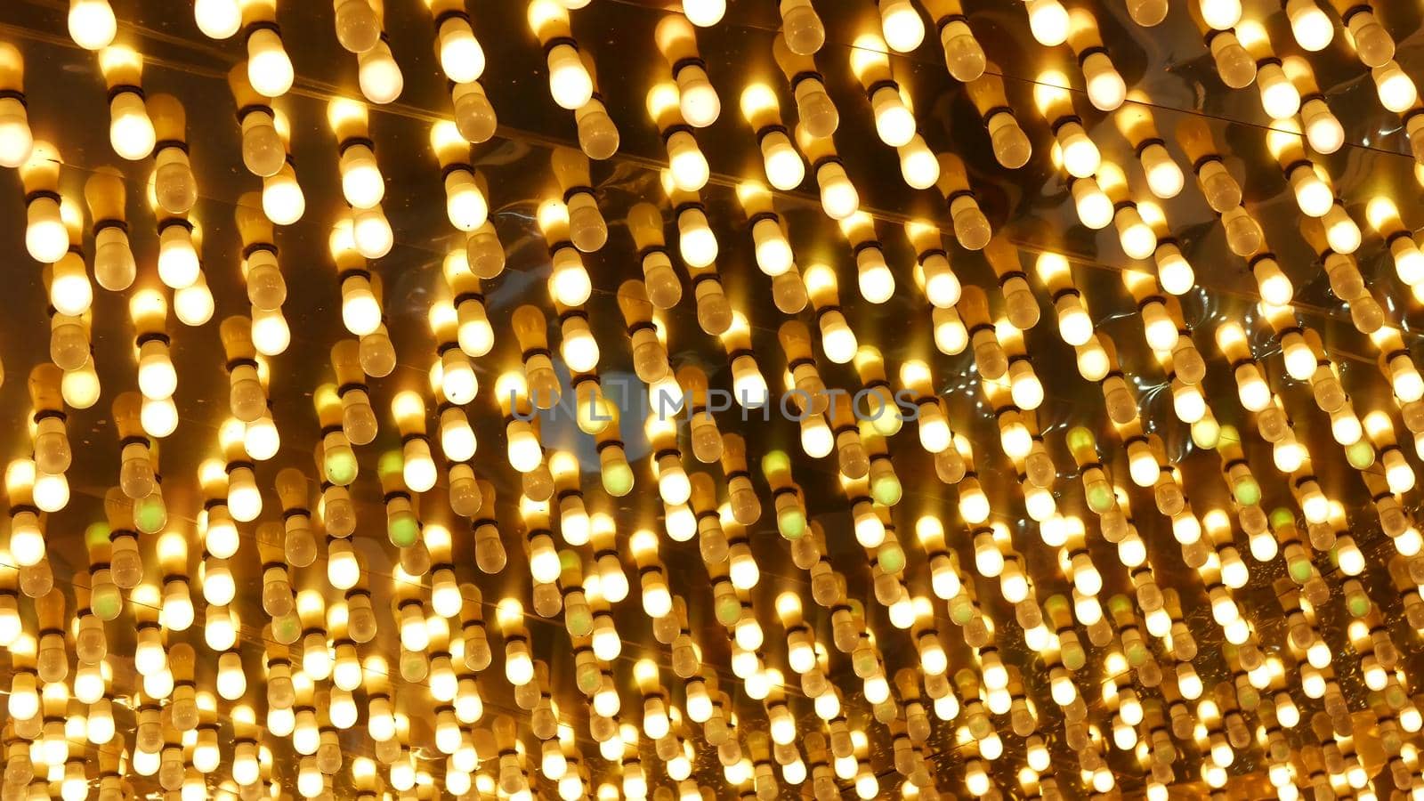 Old fasioned electric lamps blinking and glowing at night. Abstract close up of retro casino decoration shimmering in Las Vegas, USA. Illuminated vintage style bulbs glittering on Freemont street.