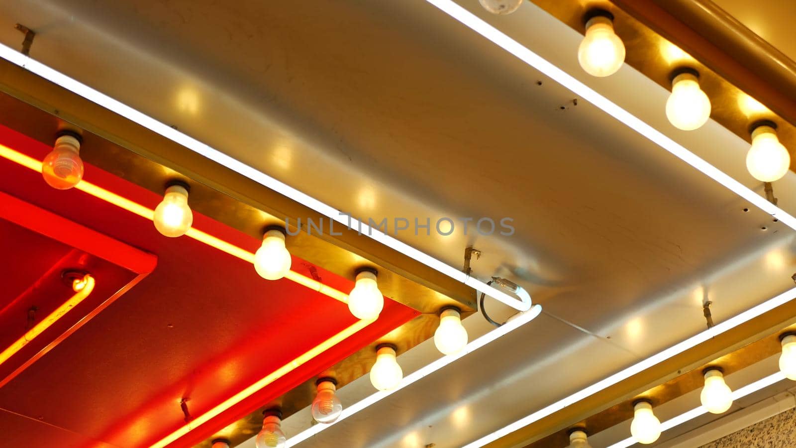 Old fasioned electric lamps blinking and glowing at night. Abstract close up of retro casino decoration shimmering in Las Vegas, USA. Illuminated vintage style bulbs glittering on Freemont street.