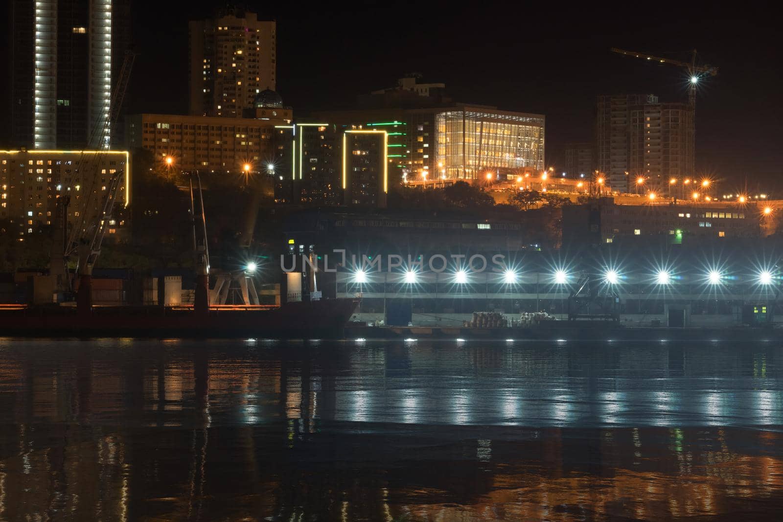 Vladivostok, Russia. Urban landscape with silhouettes of houses and light from lanterns.