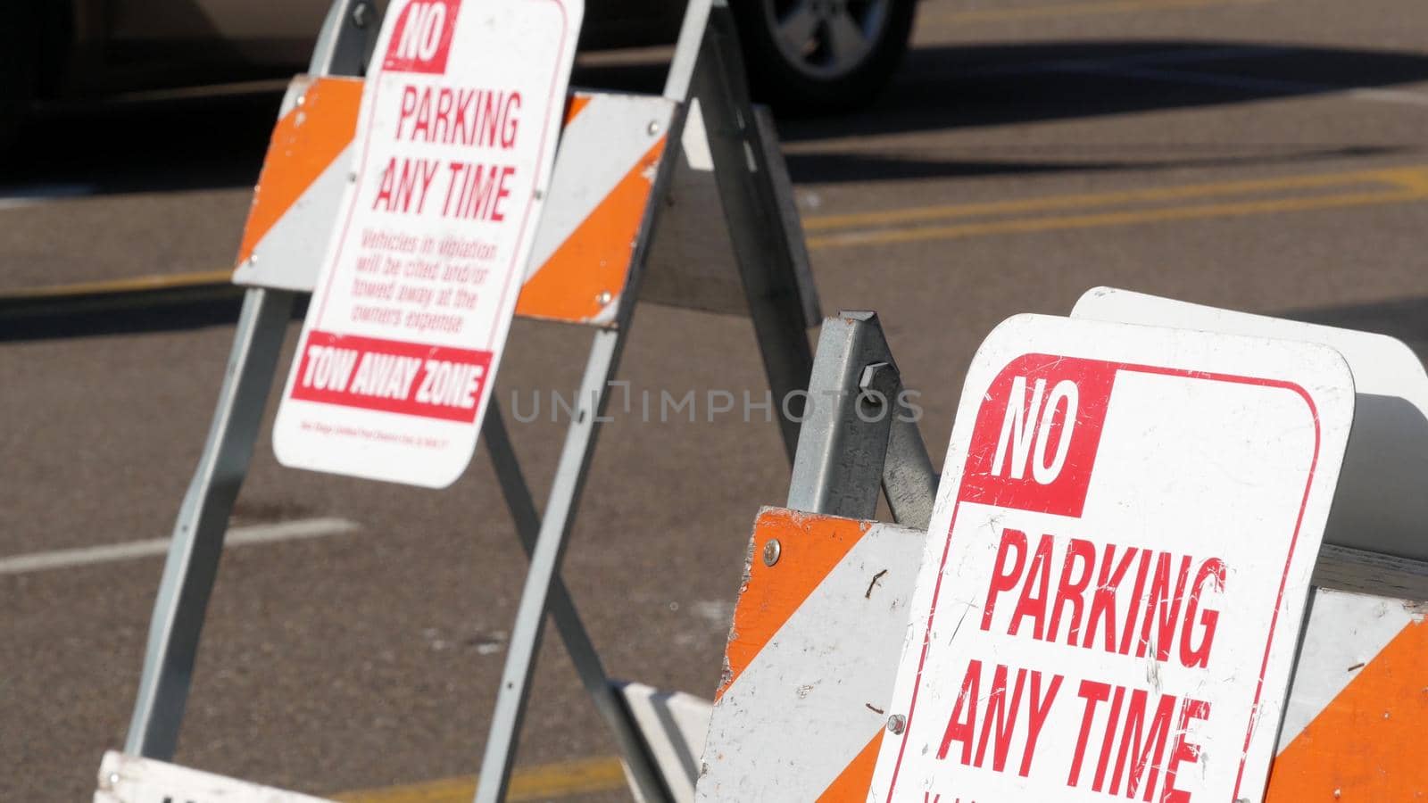 Parking lot sign as symbol of traffic difficulties and transportation issues in busy urban areas of USA. Public paid parking zone in downtown of San Diego, California. Limited space for cars in city.