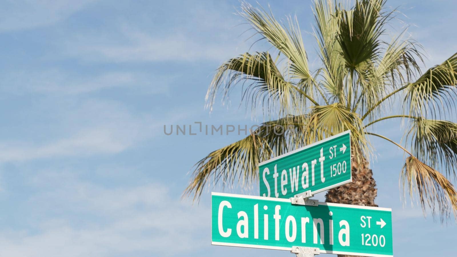 California street road sign on crossroad. Lettering on intersection signpost, symbol of summertime travel and vacations. USA tourist destination. Text on nameboard in city near Los Angeles, route 101.