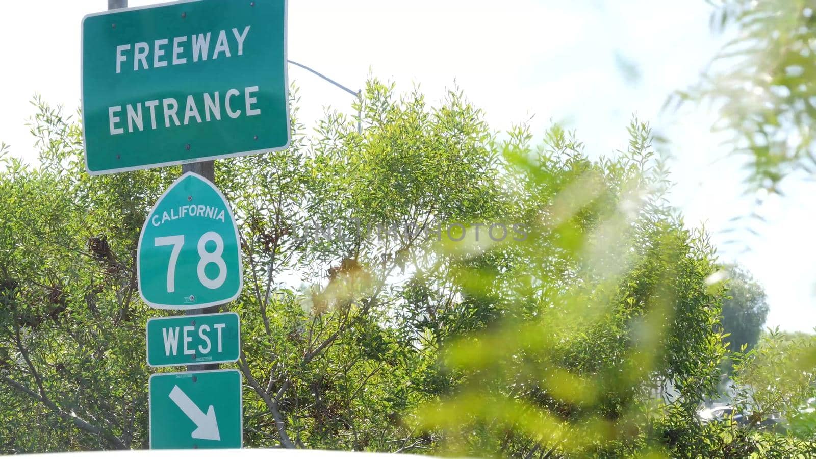 Freeway entrance sign on interchange crossraod in San Diego county, California USA. State Route highway 78 signpost plate. Symbol of road trip, transportation and traffic safety rules and regulations by DogoraSun