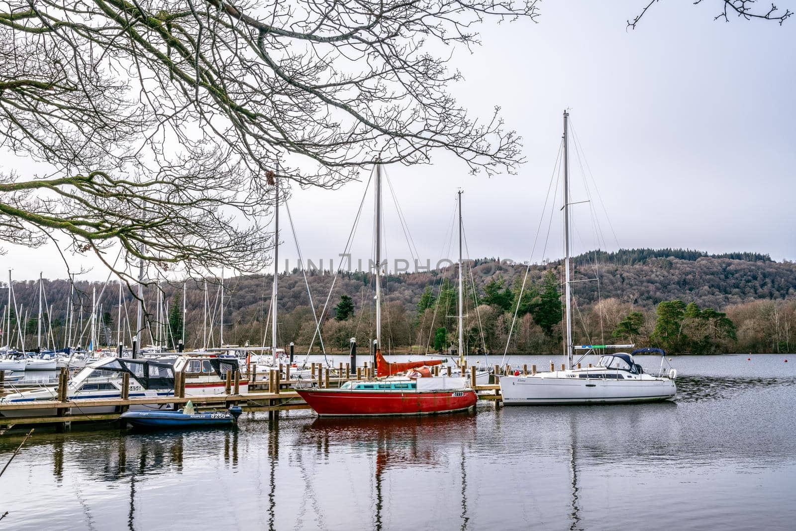 Bowness on Windermere, Cumbria, UK - February 01, 2021: Tourist pleasure boats on Bowness Bay Lake Windermere during covid lockdown