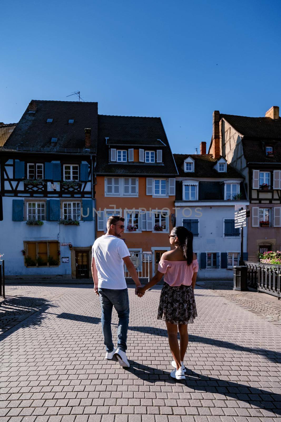 Beautiful view of colorful romantic city Colmar, France, Alsace . Europe Couple mid age men and woman on Vacation Colmar France