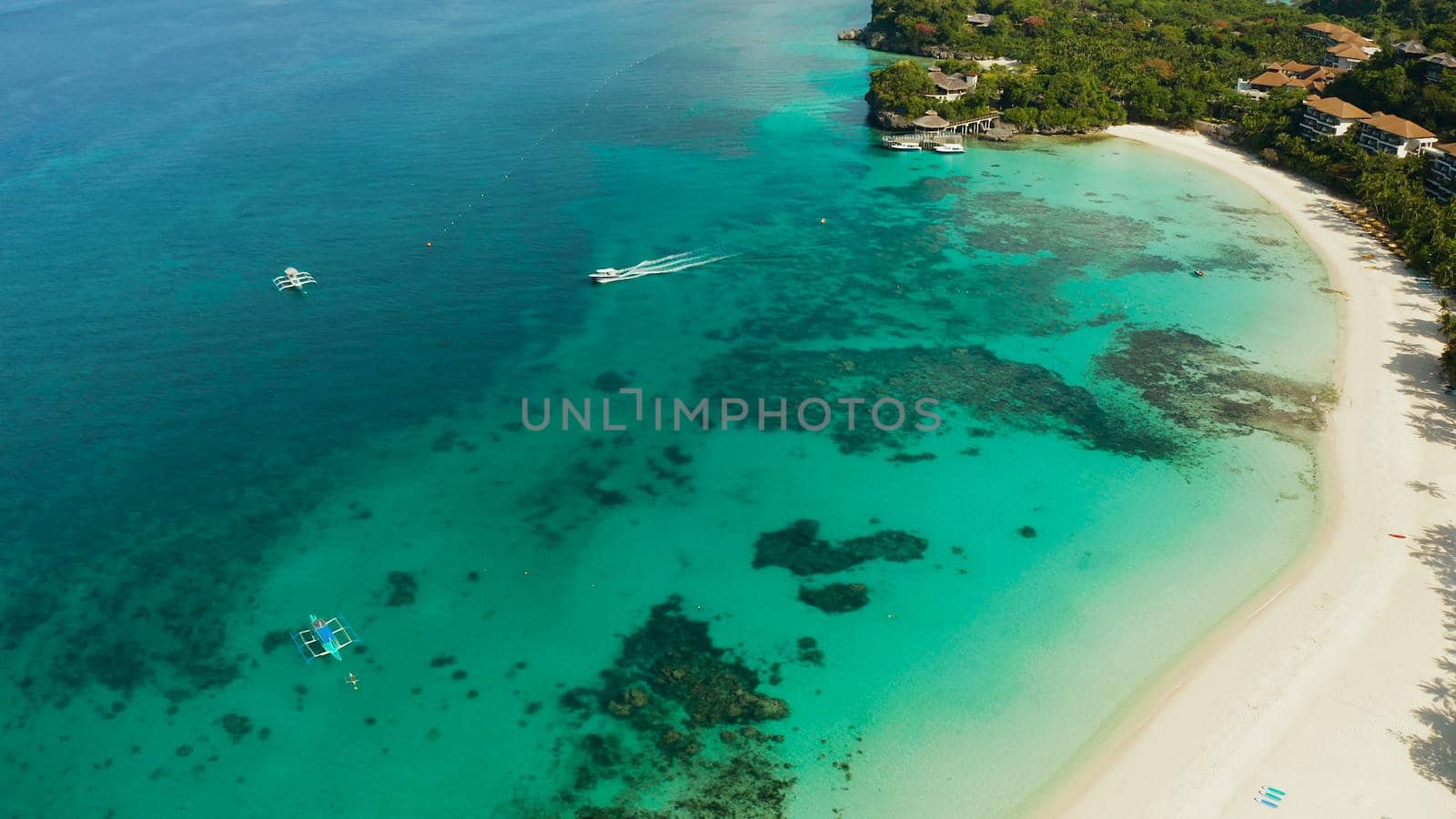 White sandy beach with tourists and hotels in Boracay Island, Philippines, aerial view. Seascape with beach on tropical island. Summer and travel vacation concept.