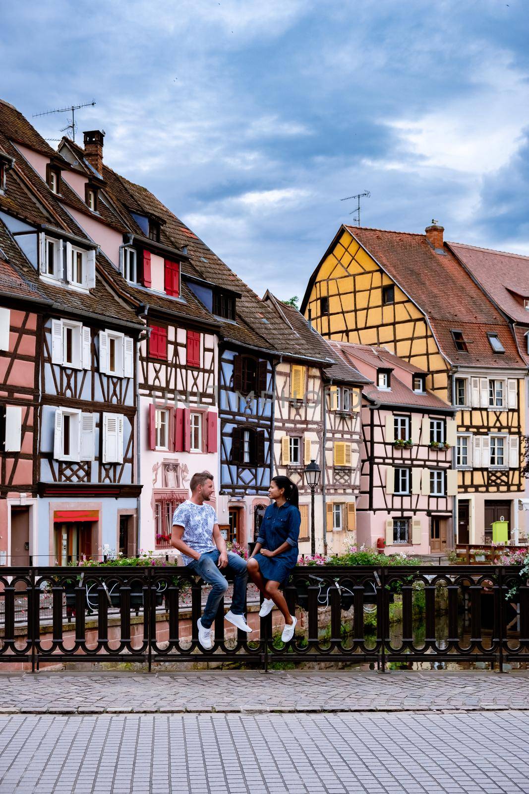 Beautiful view of colorful romantic city Colmar, France, Alsace . Europe Couple mid age men and woman on Vacation Colmar France