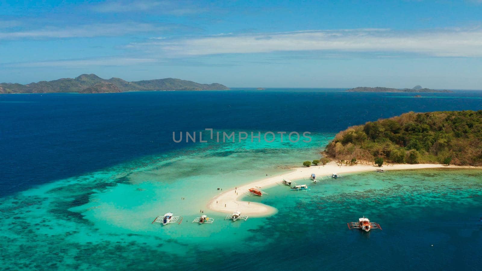 aerial seascape tropical island with sand bar, turquoise water and coral reef. Ditaytayan, Palawan, Philippines. tourist boats on tropical beach. Travel tropical concept. Palawan, Philippines