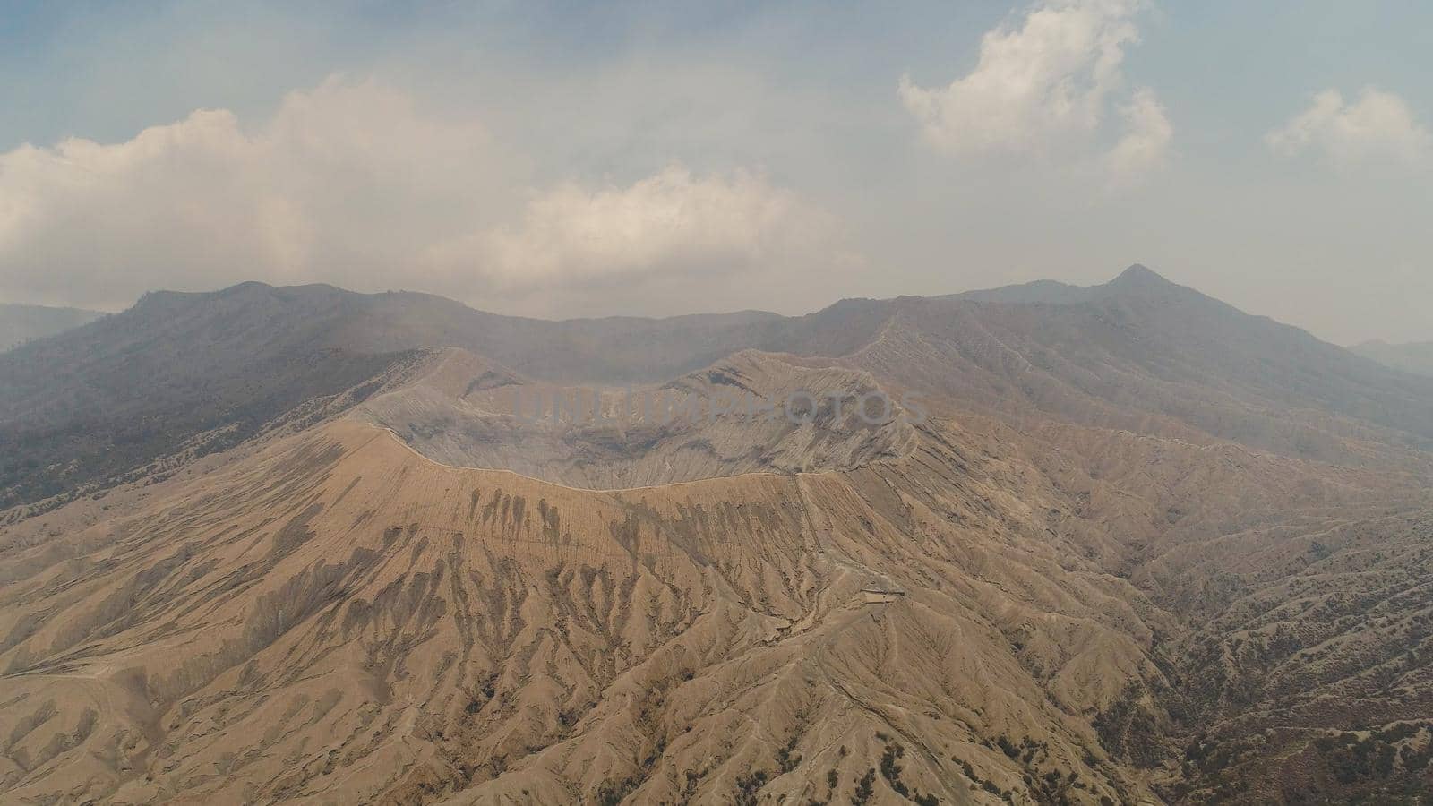 active volcano Bromo with smoking crater. aerial view mountain landscape volcano crater and mountains Tengger Semeru national park.