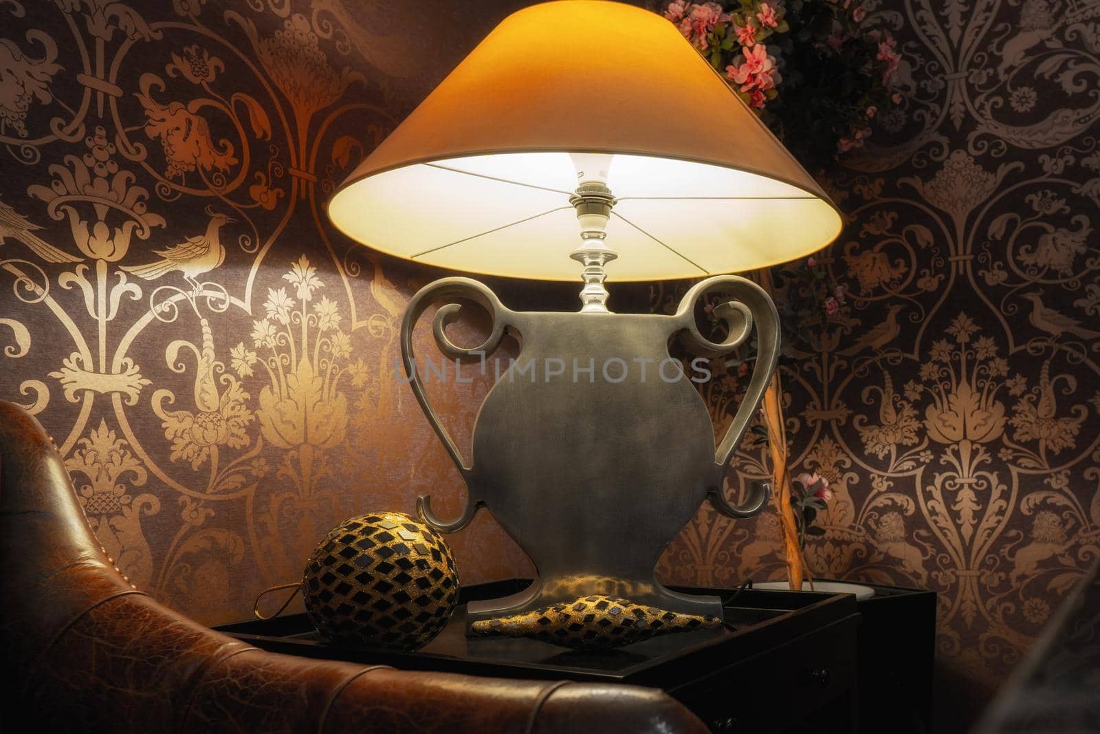 Yellow Shade, Silver Foot Lamp in Vintage Environment with Leather Sofa in Front