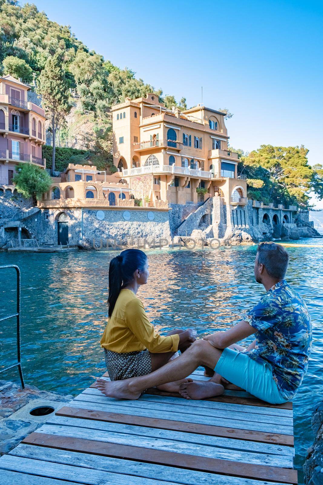 Beautiful sea coast with colorful houses in Portofino, Italy Europe Portofino in Liguria, Italy. Genoa Couple mid age man and woman visiting Italy during vacation