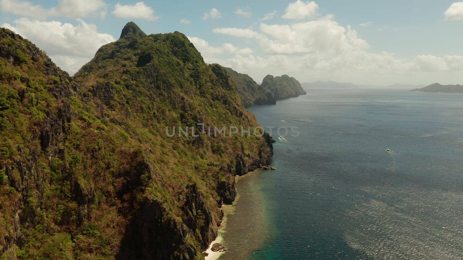Bay and the tropical islands. Seascape with tropical rocky islands, ocean blue wate, aerial view. islands and mountains covered with tropical forest. El nido, Philippines, Palawan. Tropical Mountain Range
