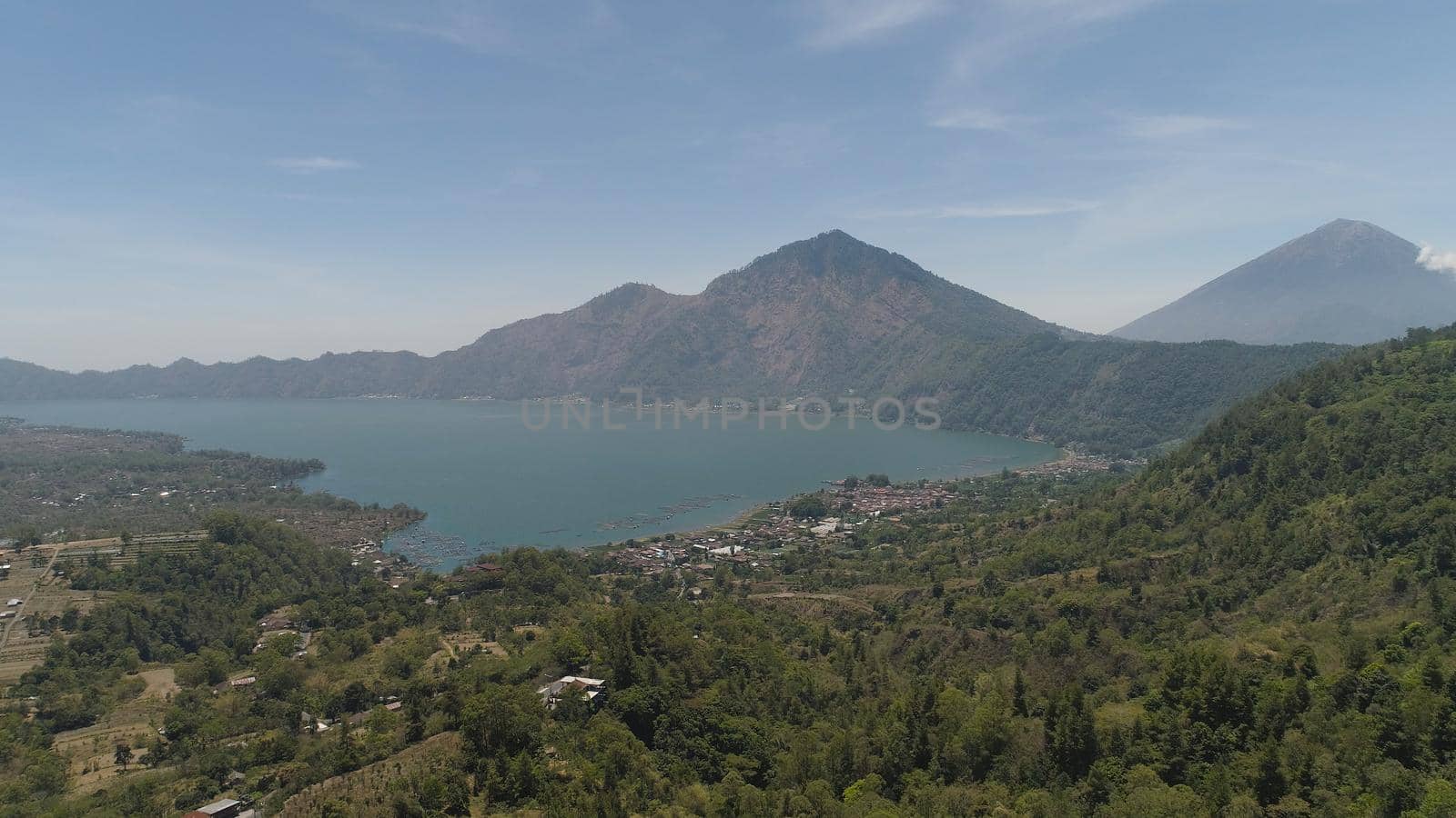 Aerial view crater lake and volcano Batur mountain landscape with volcanoes, lake with sky and clouds Bali, Indonesia. Travel concept.