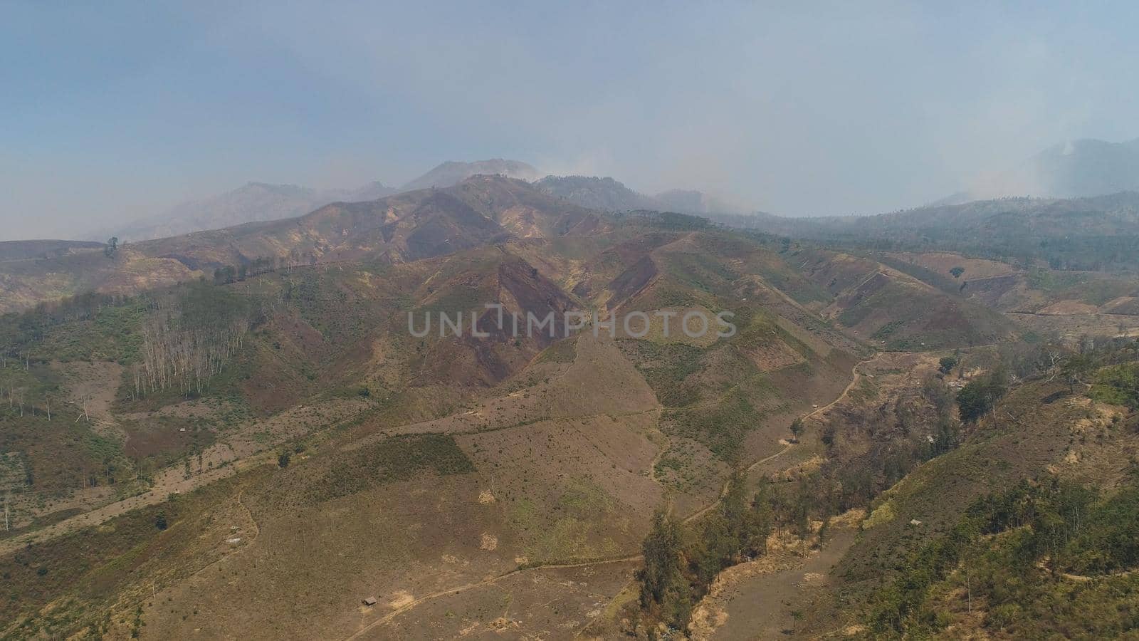 Mountain hilly landscape in rural areas with agricultural land in Java Indonesia. aerial view slopes mountains covered with vegetation. mountain landscape