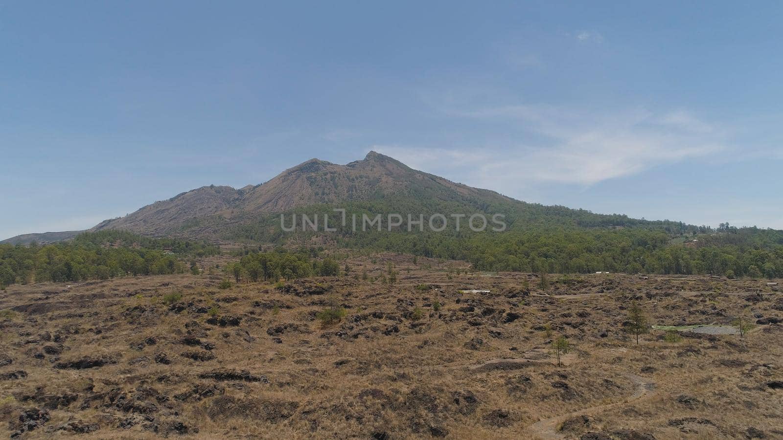 Aerial view volcano batur covered with vegetation mountain landscape with volcano sky and clouds Bali, Indonesia. Travel concept.