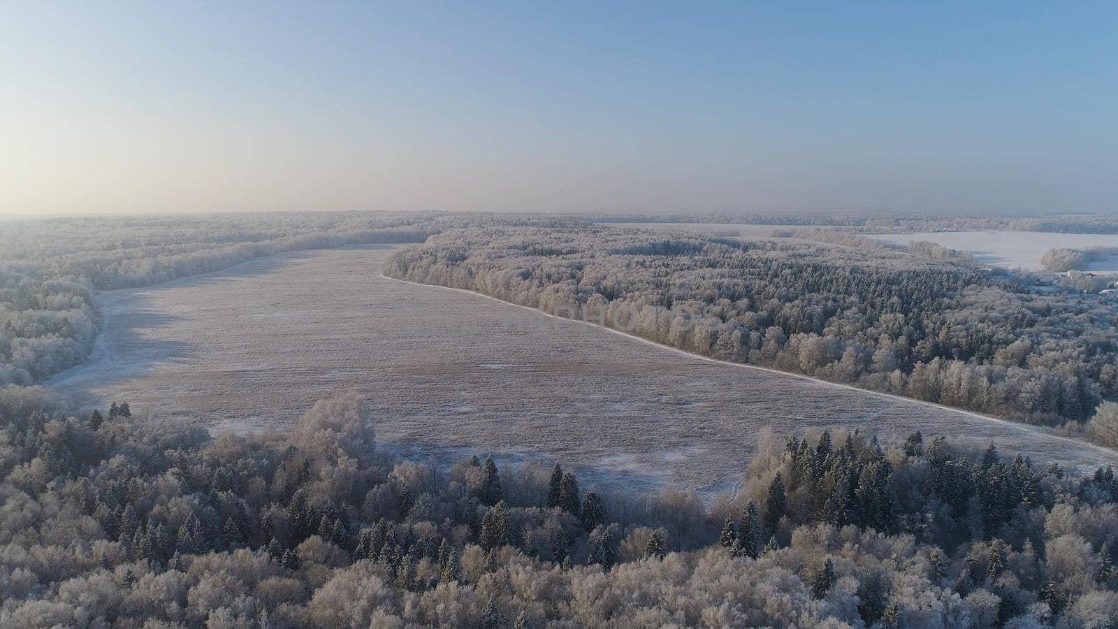 aerial view winter landscape snow covered field and trees in countryside. winter in countryside. Snow covered farmland and trees during winter