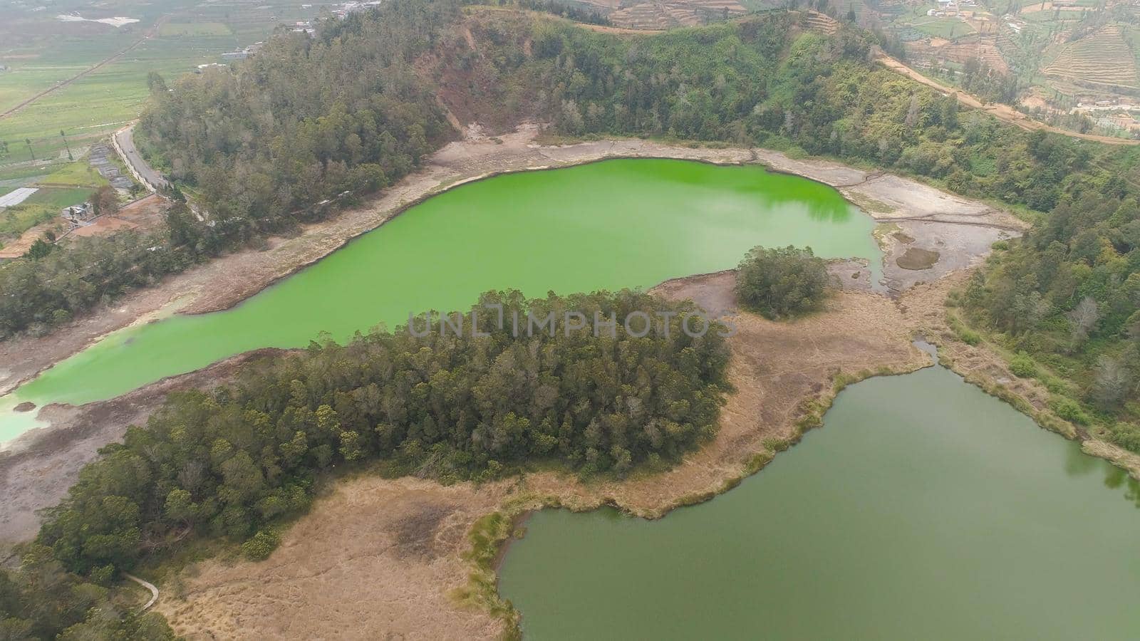 volcanic sulfur lake telaga warna in dieng plateau, java Indonesia. mountain tropical landscape lake with green water among mountains. this lake is one mainstay tourist destinations in Wonosobo Regency
