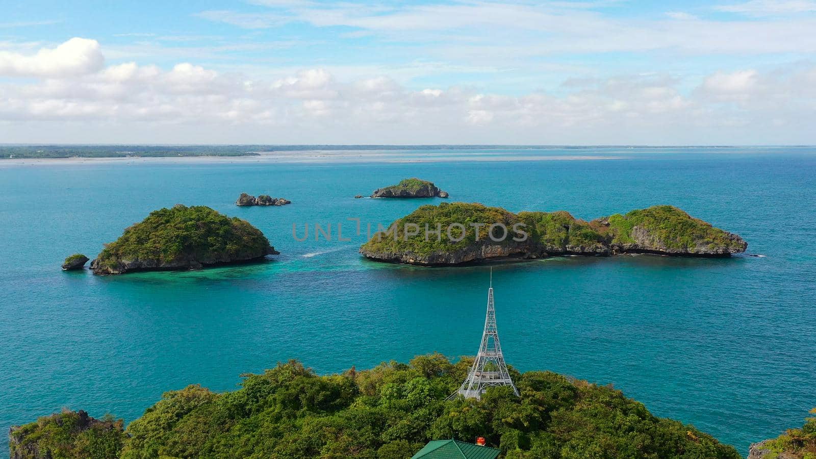 Seascape with a cluster of tropical Islands in turquoise water, aerial seascape. Hundred Islands National Park, Pangasinan, Philippines. Famous tourist attraction, Alaminos. Summer and travel vacation concept