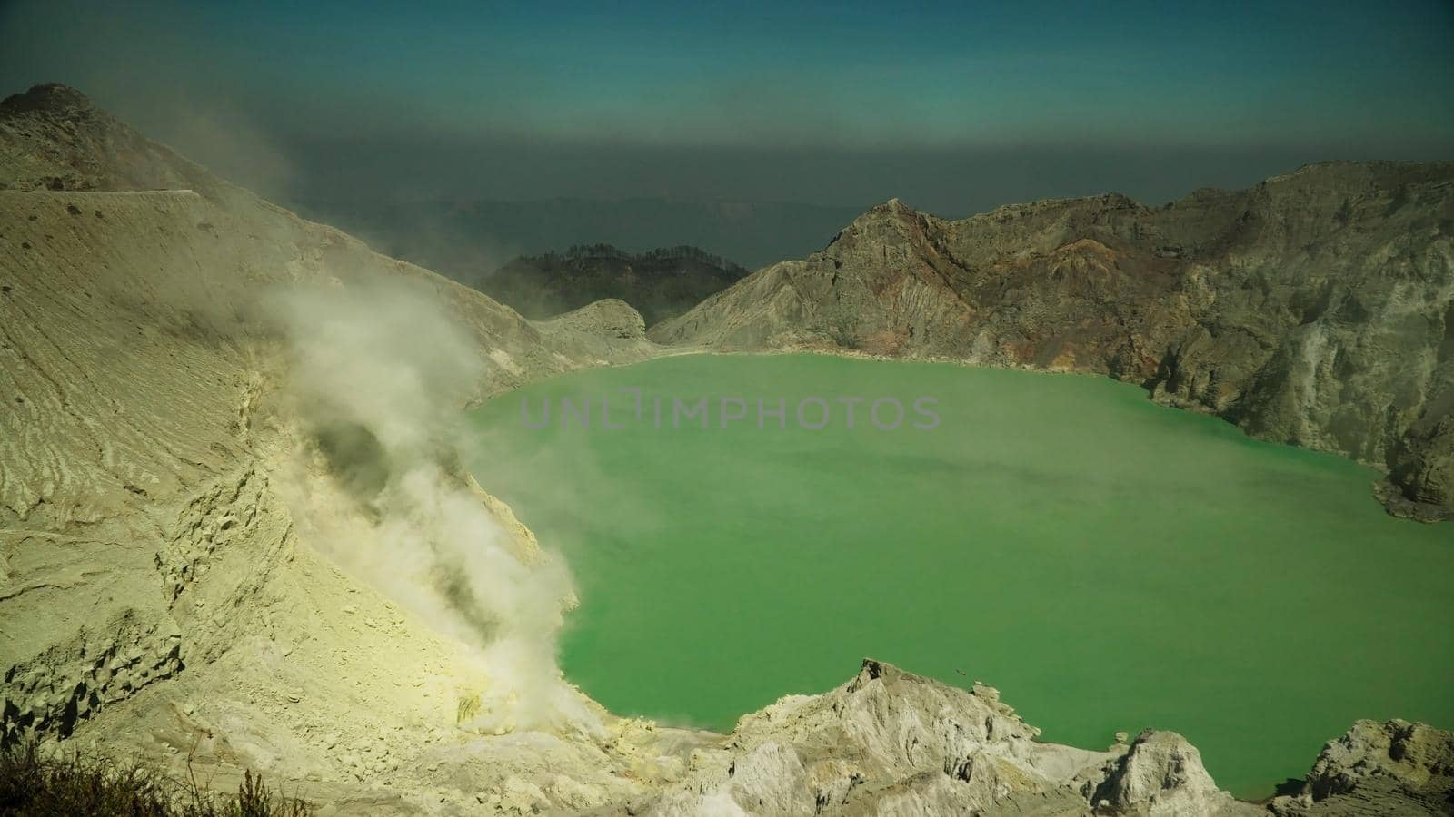 crater acid lake Kawah Ijen where sulfur is mined. Sulfur gas, smoke. mountain landscape Ijen volcano complex group of stratovolcanoes in East Java Indonesia