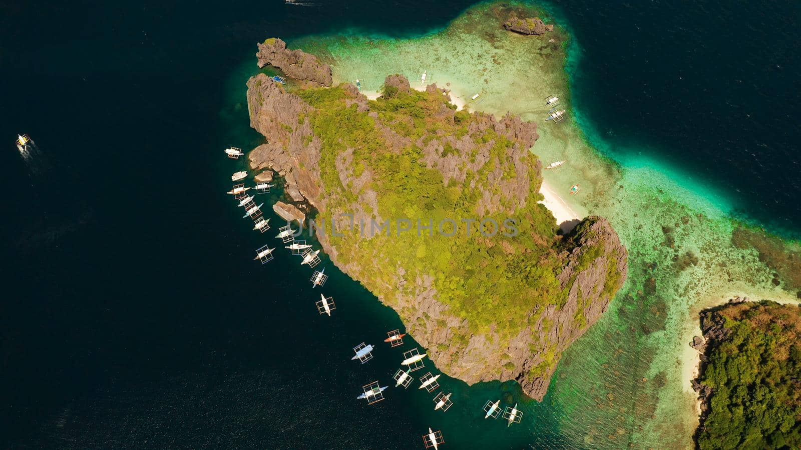 Tourist boats over tropical lagoon and coral reef, aerial view. El nido, Philippines, Palawan. Summer and travel vacation concept.
