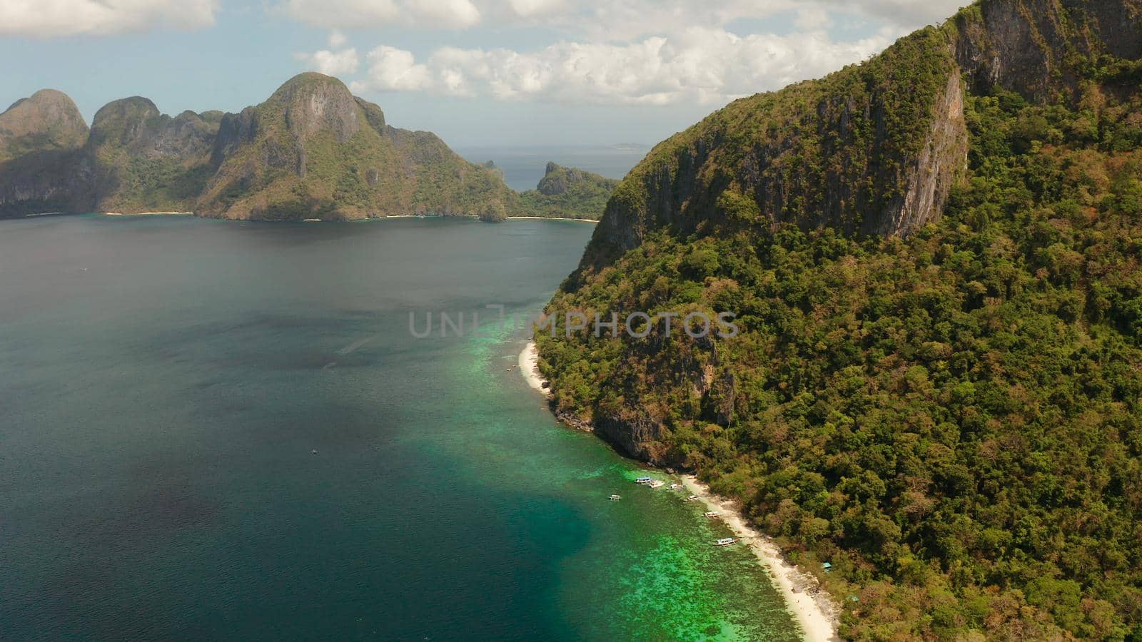Tropical beach and clear blue water. El nido, Philippines, Palawan. Seascape with tropical rocky islands, ocean blue water. Summer and travel vacation concept