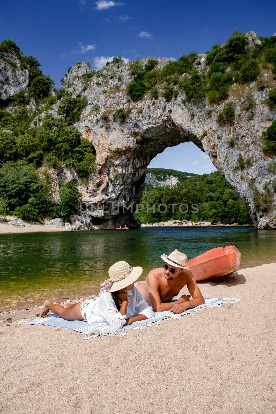 couple men and woman visiting The famous natural bridge of Pont d'Arc in Ardeche department in France Ardeche. Europe Rhone Alpes